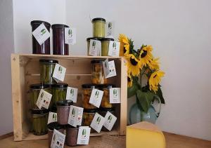 a shelf filled with jars of food next to a vase at Hoamisch in Malles Venosta
