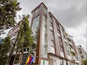 a building with a clock tower on top of it at NPG Hotel, Near Kempegowda International Airport in Dod Jāla
