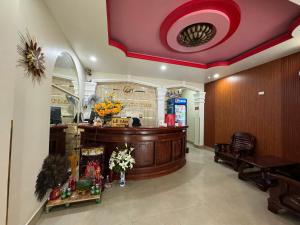 a lobby with a reception desk in a building at Khách Sạn Lộc Thọ in Ho Chi Minh City