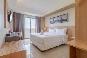 Postel nebo postele na pokoji v ubytování Horison Le Aman Bali