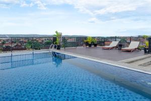 a swimming pool on the roof of a building at Horison Le Aman Bali in Jimbaran