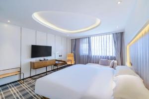 Letto o letti in una camera di Bingo-威尔顿酒店-昆明火车站云纺商业城店