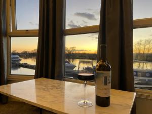 a bottle of wine sitting on a table with a glass at On the river Severn - Severnside Boat & Caravan Park, Caravan 9 in Tirley
