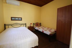 a bedroom with two beds and a dresser at Ioannis House Apartment in Asprovalta