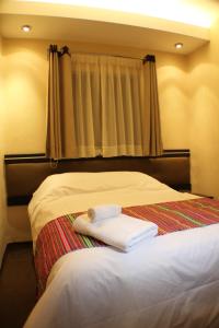Voodi või voodid majutusasutuse Tampu Hotel toas
