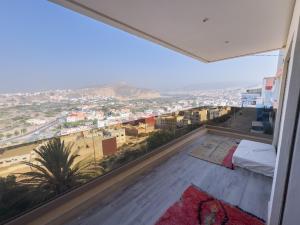 a bedroom with a view of a city at villa with views in Agadir +22 photos