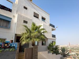 a building with a palm tree in front of it at villa with views in Agadir