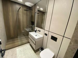 a bathroom with a sink and a shower and a toilet at Royal Class of the City centre-Adults Only in Chişinău
