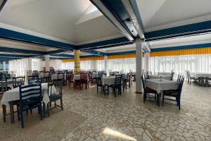 a dining room with tables and chairs in a building at Hotel Miorita Neptun in Neptun