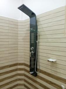 a shower in a bathroom with a black shower head at Yala Eco Shine in Tissamaharama