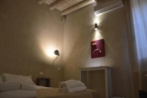 
a room with a bed, a lamp, a lamp post, and a at Secret B&B in Trapani
