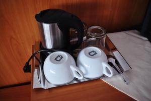 a tray with a coffee pot and cups on a table at Apartmány EKOSERVIS SLOVENSKO in Veľký Slavkov +13 photos