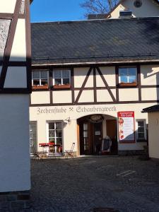 a building with a sign on the front of it at Ferienwohnung Rote-Villa in Marienberg