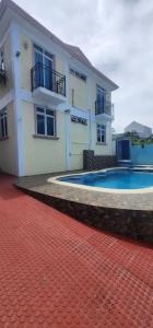 a house with a swimming pool in front of it at Charming villa in Flic en Flac with private pool in Flic-en-Flac