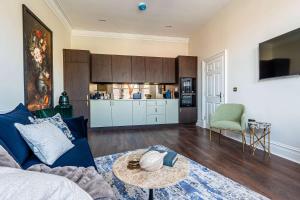 a living room with a blue couch and a table at No 50 - 2nd Floor Beautiful one bed apartment in Liverpool Sleeps 4 in Liverpool