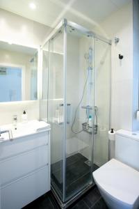 a bathroom with a shower and a toilet and a sink at Panoramic view Gavà Mar in Gavà
