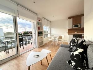 a living room with a couch and a table at Panoramic view Gavà Mar in Gavà