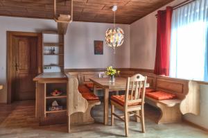 a dining room with a table and a wood stove at Waldpension Schiefling am See in Schiefling am See