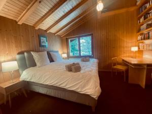 a bedroom with a bed with two towels on it at Christiania 431 in Bagnes