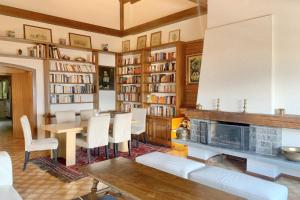 a living room with a fireplace and a table and chairs at Christiania 431 in Bagnes
