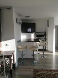a kitchen with a table and stools in a room at Monaco' hills appartement in Roquebrune-Cap-Martin +7 photos