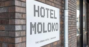 a sign on the side of a brick building at Moloko, modern designed sleep & shower hotel in city center, Digital key by SMS in Enschede