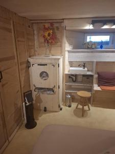 a small bathroom with a sink and a table at Home&Classic - Alte Werkstatt in Effelder