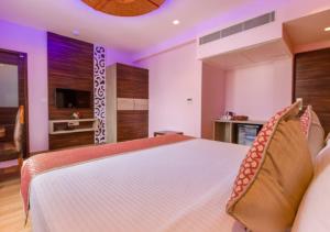 a bedroom with a large bed and a television at NPG Hotel, Near Kempegowda International Airport in Dod Jāla +16 photos