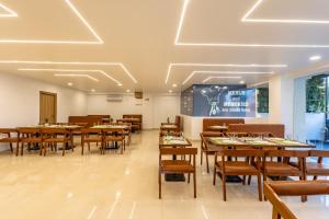 a dining room with wooden tables and chairs at Hiwa Boutique Hotel in Hyderabad