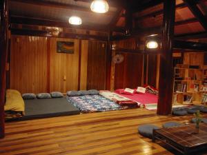 a room with a bed in a room with wooden walls at An's home Mộc Châu in Mộc Châu