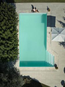 a person sitting on a bench next to a blue painting at Eliathos Hillside Retreat in Archanes