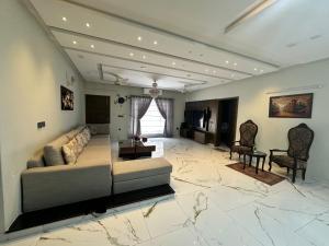 a large living room with a couch and a television at Villa Islamabad Central Hill View Park View in Islamabad
