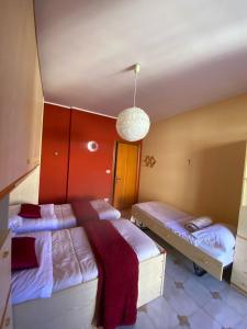 a bedroom with two twin beds and a hanging light at Casa MaRo' in Capaci
