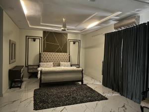 a living room with a couch and a rug at Villa Islamabad Central Hill View Park View in Islamabad +25 photos