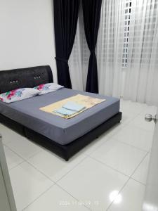 a bed in a bedroom with a blue mattress at Prima Resident Meru Ipoh in Ipoh