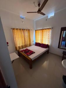 a bedroom with a large bed in a room at Aikya homestay , Indian tourists only in Gokarna