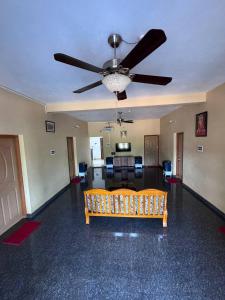 a living room with a ceiling fan and a couch at Aikya homestay , Indian tourists only in Gokarna +38 photos