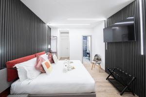 TV a/nebo společenská místnost v ubytování Teulada Luxury Rooms