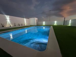 a swimming pool in the middle of a yard at night at Fuerte Roche 2 in Tuineje