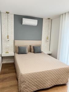 a bedroom with a large bed with blue walls at Casinha in Celorico de Basto