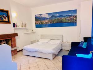 a bedroom with a bed and a painting on the wall at Gigi House in Verbania
