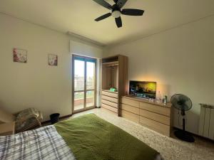 a bedroom with a bed and a flat screen tv at Private and quiet room in Rome