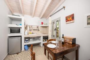 a kitchen with a wooden table and a dining room at Stefanos Cottage in Longos