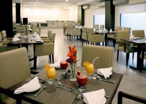 a dining room with tables and chairs with wine glasses at Avari Boutique Gujranwala in Fattu Mand