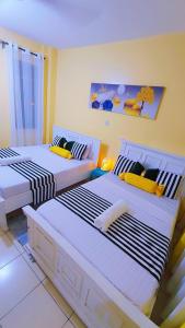 a room with two beds in a room at Marvel Homes Two Bedroom Air-Bnb Mombasa Bamburi in Bamburi