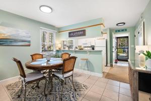 a kitchen and dining room with a table and chairs at 55-2 Low Country Get-A-Way condo in Pawleys Island