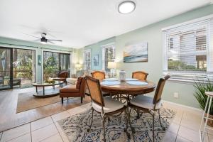 a dining room with a table and chairs at 55-2 Low Country Get-A-Way condo in Pawleys Island +19 photos