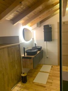 a bathroom with two sinks and a mirror at Loulipo in Gerbépal +28 photos