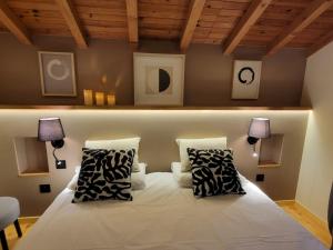 a bedroom with a white bed with two pillows at Loulipo in Gerbépal