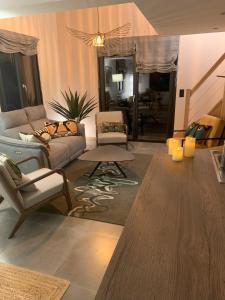 a living room with a couch and chairs and a table at Loulipo in Gerbépal